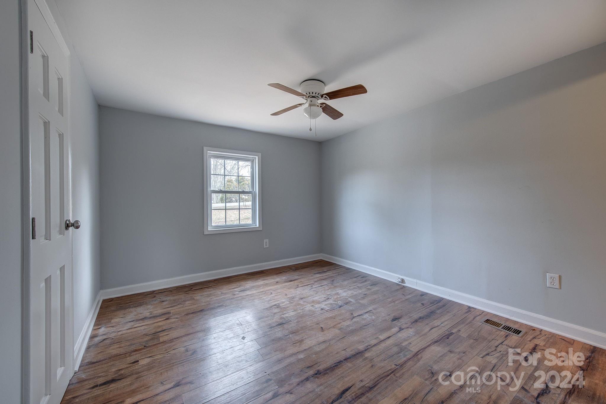 2714 Rufus Ratchford Road Gastonia, NC 28056 - Photo 18 of 28 a view of empty room with wooden floor and fan