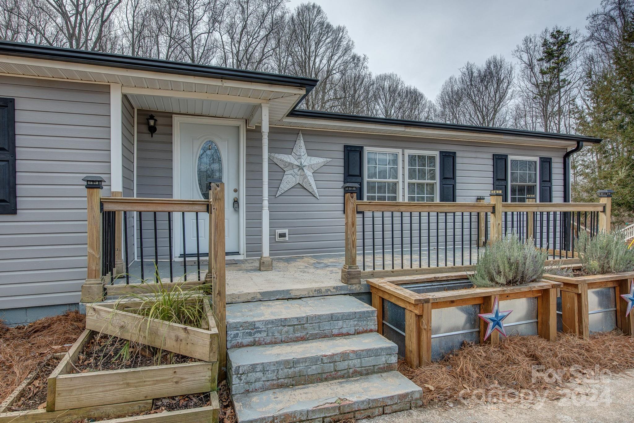 2714 Rufus Ratchford Road Gastonia, NC 28056 - Photo 2 of 28 a view of a house with wooden deck and furniture
