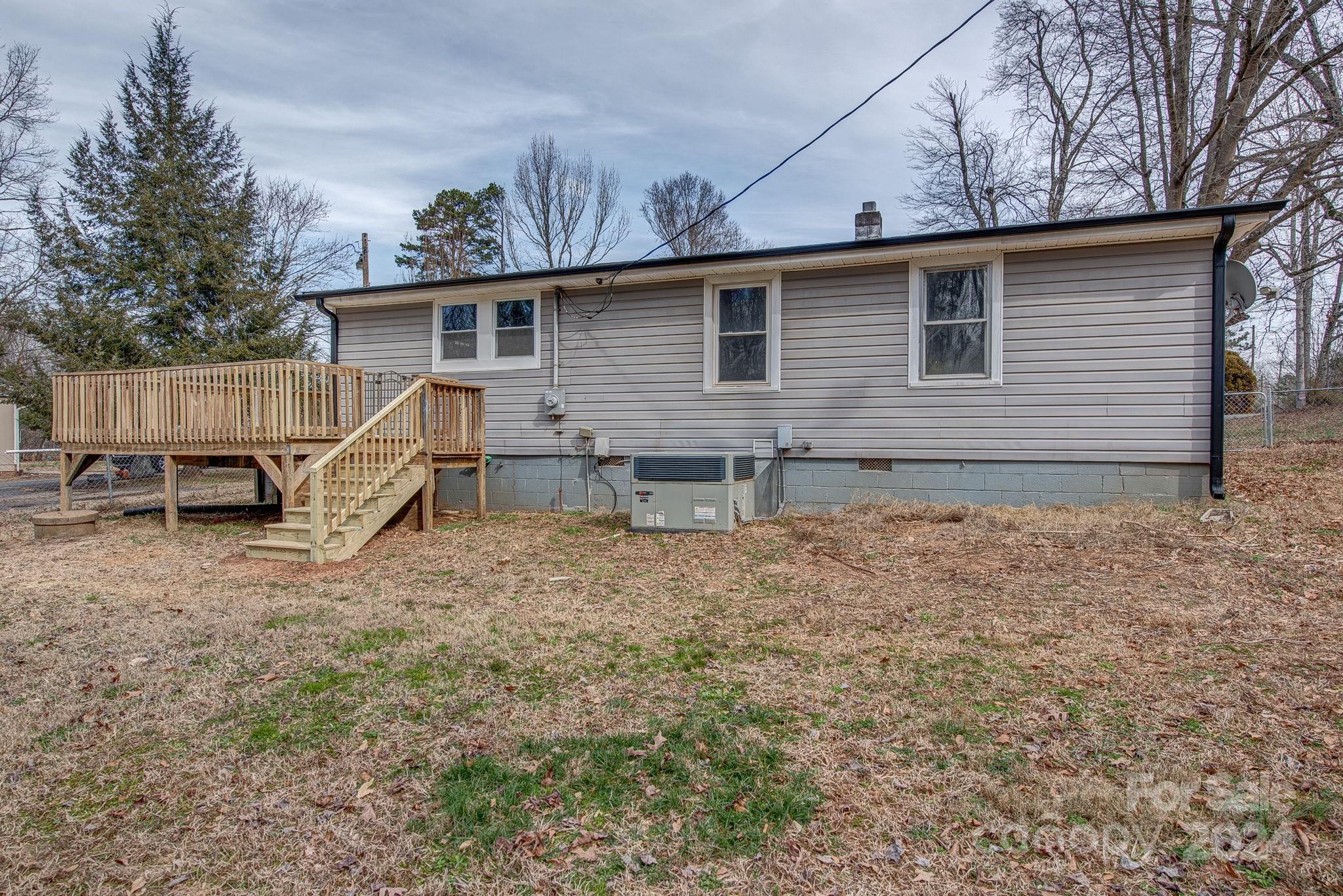 2714 Rufus Ratchford Road Gastonia, NC 28056 - Photo 23 of 28 a view of a house with a yard chairs and wooden fence