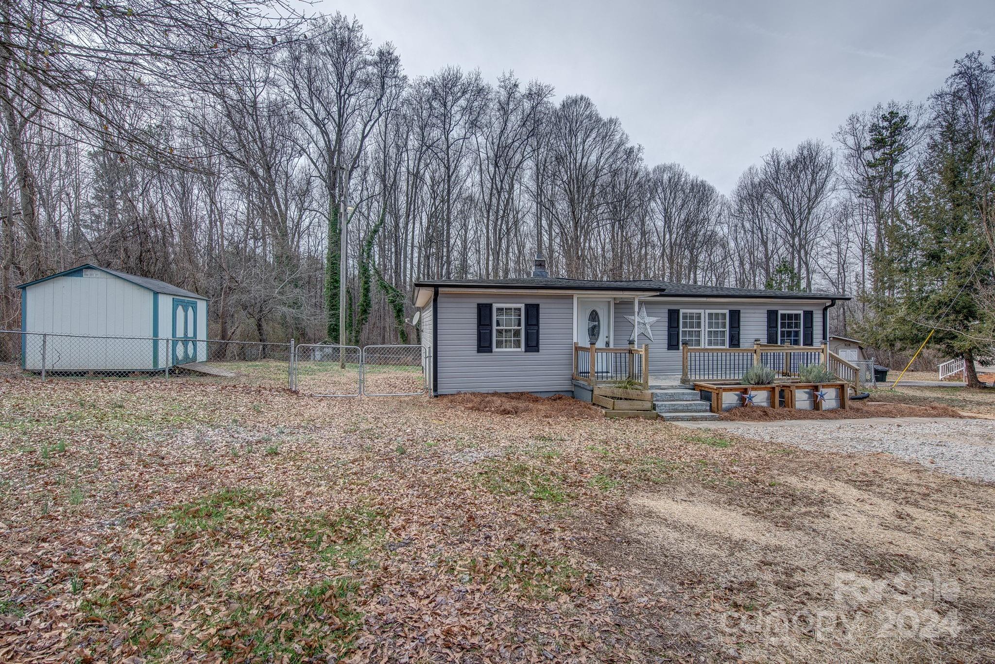 2714 Rufus Ratchford Road Gastonia, NC 28056 - Photo 4 of 28 a view of a house with a yard and sitting area
