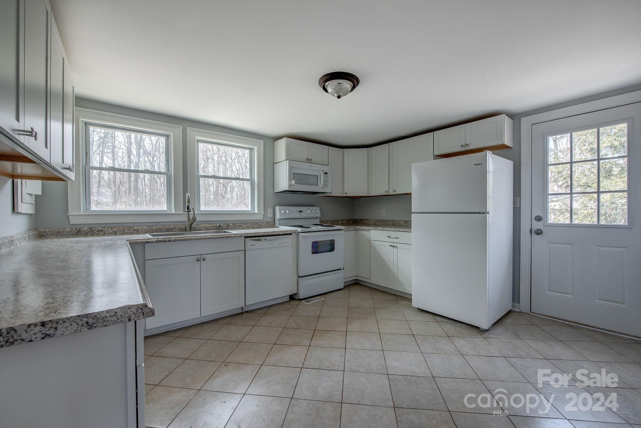 2714 Rufus Ratchford Road Gastonia, NC 28056 - Photo 5 of 28 a kitchen with a refrigerator a sink and cabinets