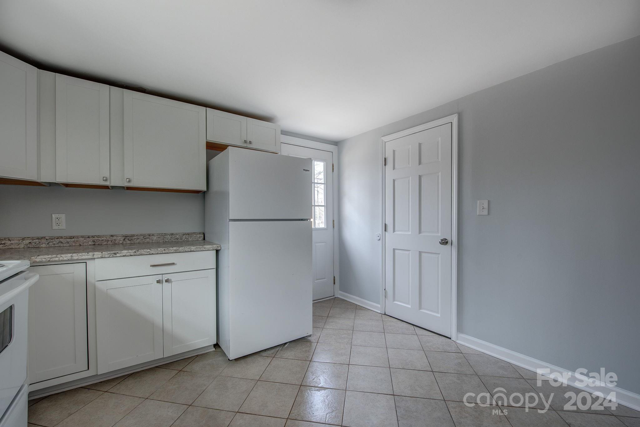 2714 Rufus Ratchford Road Gastonia, NC 28056 - Photo 8 of 28 a kitchen with cabinets and a refrigerator