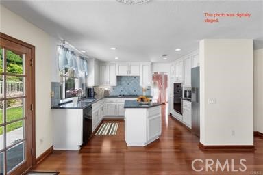 1611 San Almada Road Corona, CA 92882 - Photo 4 of 9 a kitchen with stainless steel appliances granite countertop a refrigerator sink and stove