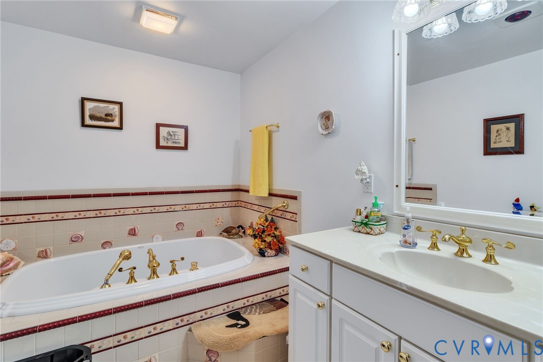 4400 Hacks Neck Road Heathsville, VA 22473 - Photo 40 of 78 a bathroom with a sink and a mirror