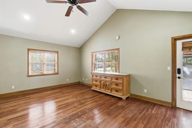 a view of a room with wooden floor and window