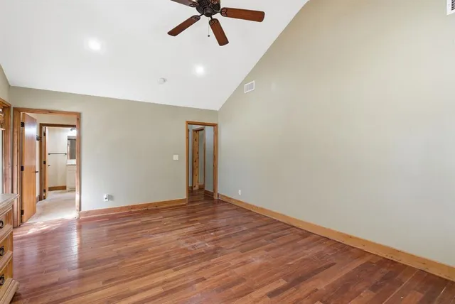 a view of an empty room with wooden floor