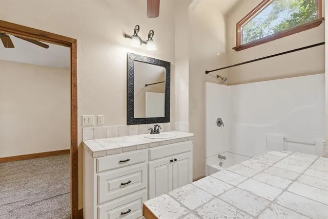 a en suite bathroom with a double vanity sink and a mirror