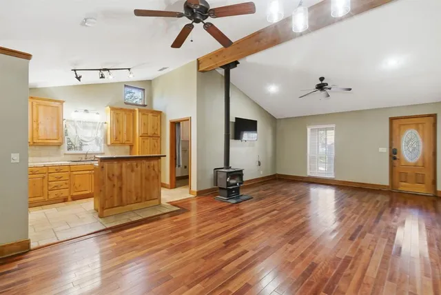 a view of a kitchen with wooden floor and a ceiling fan