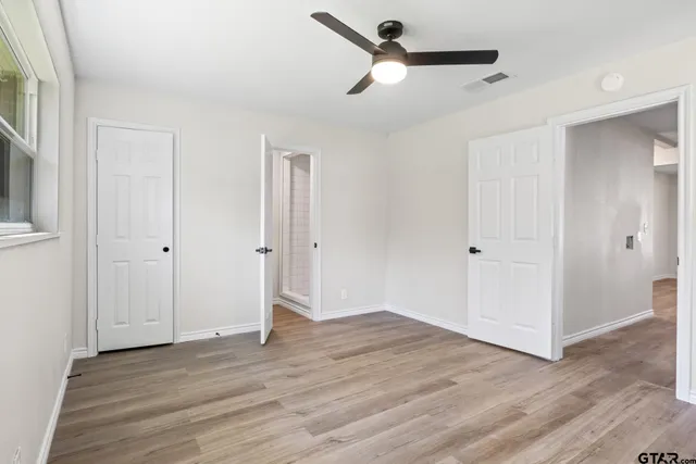 a view of empty room with wooden floor