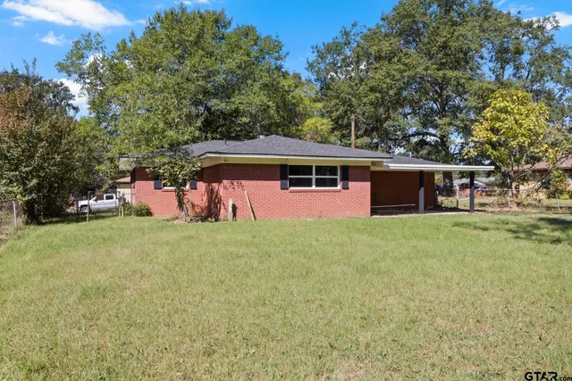 a view of a house with a backyard patio and swimming pool