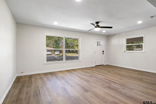 wooden floor in an empty room with a window