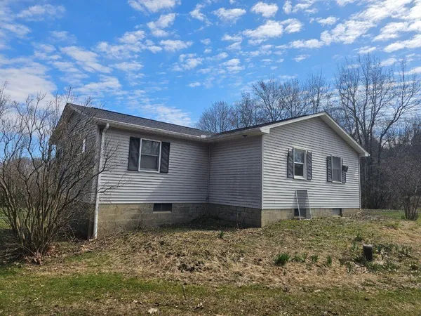 a backyard of a house with large trees