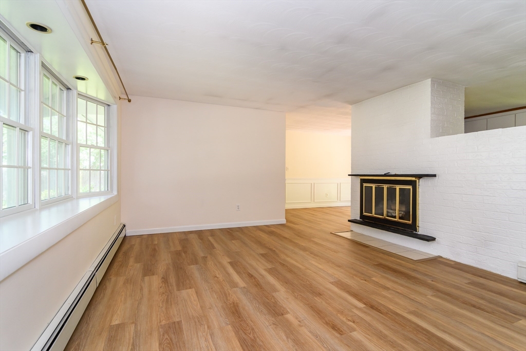 33 Eisenhower Road Framingham, MA 01701 - Photo 3 of 20 a view of an empty room with wooden floor and a window