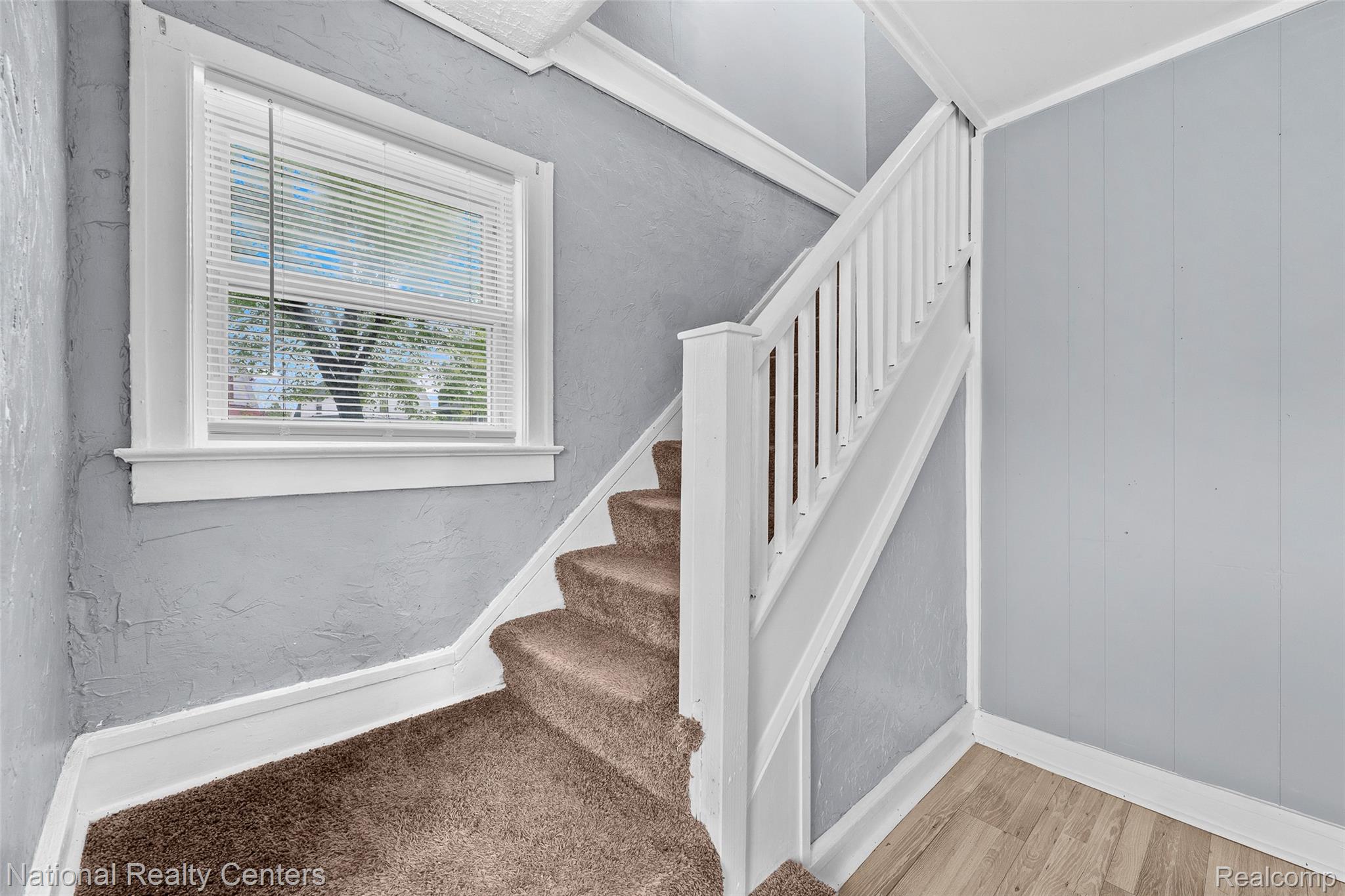 686 Perry Street Pontiac, MI 48342 - Photo 14 of 26 Stairway with baseboards and wood finished floors
