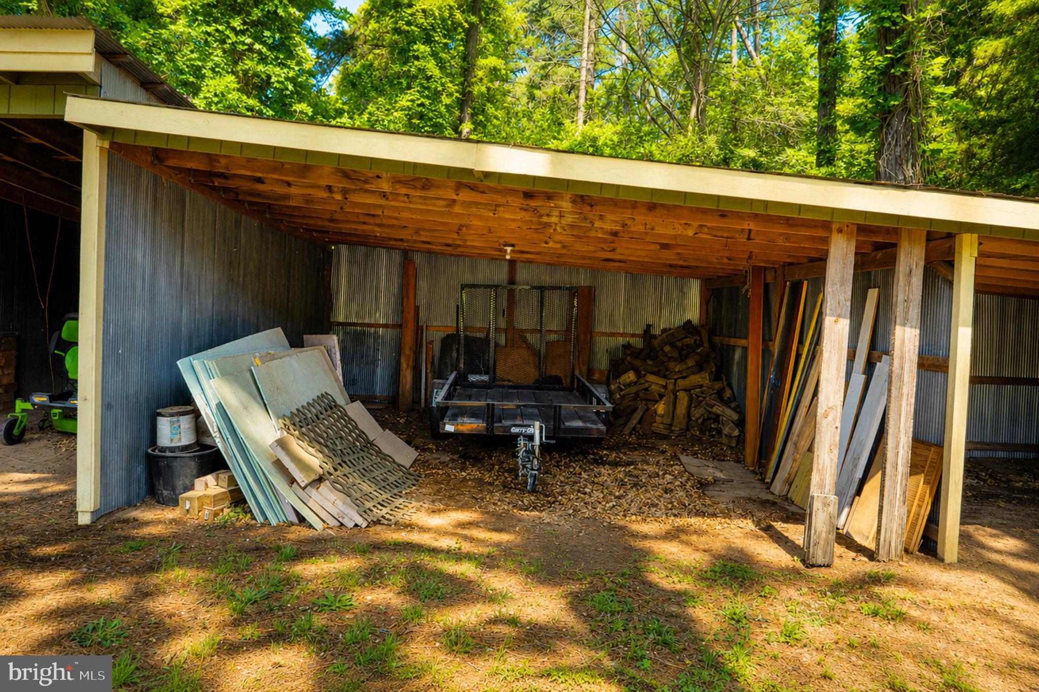 610 Beach Road White Stone, VA 22578 - Photo 20 of 23 Rustic storage space under trees.