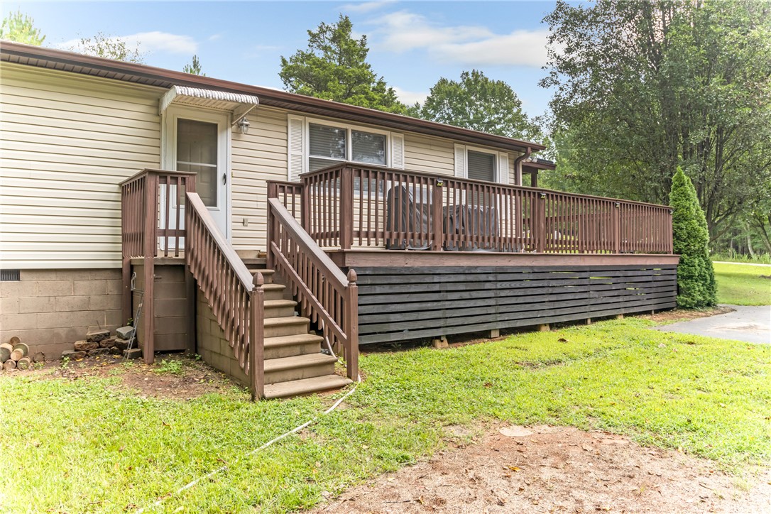 404 Davis Road Liberty, SC 29657 - Photo 31 of 39 An inviting raised deck offers outdoor living space, complementing the home's practical and cozy exterior.