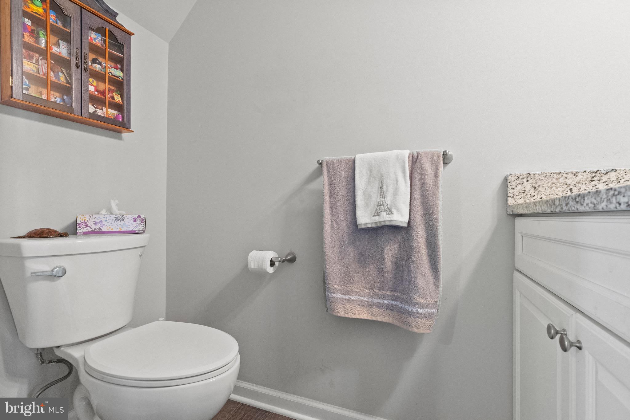 2297 Memorial Court Atco, NJ 08004 - Photo 11 of 21 a white toilet sitting next to a bathroom sink