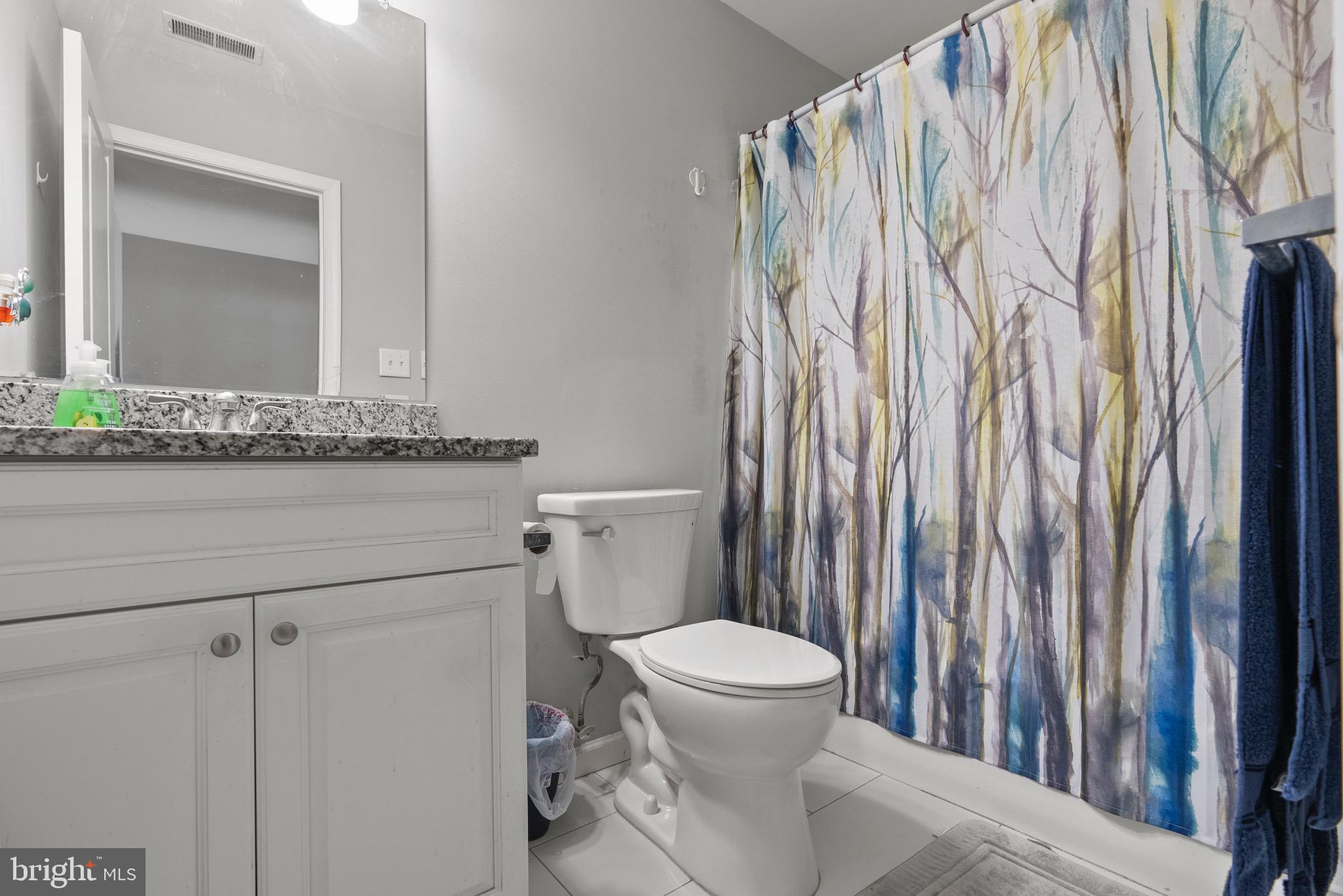 2297 Memorial Court Atco, NJ 08004 - Photo 13 of 21 a white toilet sitting next to a bathroom sink