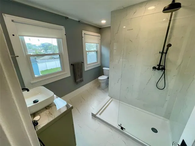 a bathroom with a bathtub sink a toilet and a shower