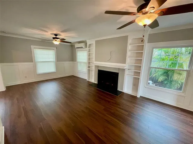 a view of empty room with wooden floor