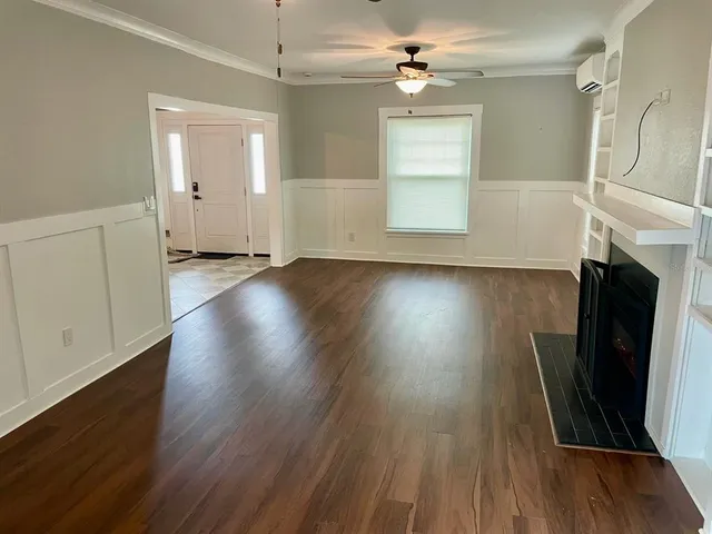 wooden floor in an empty room with a fireplace