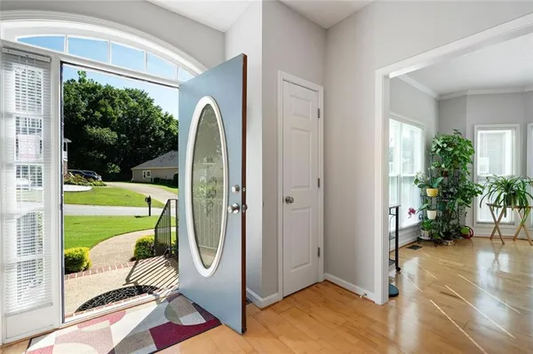 a kitchen with stainless steel appliances granite countertop a sink dishwasher stove and refrigerator with wooden floor