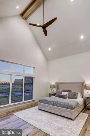 a spacious bedroom with a bed and window