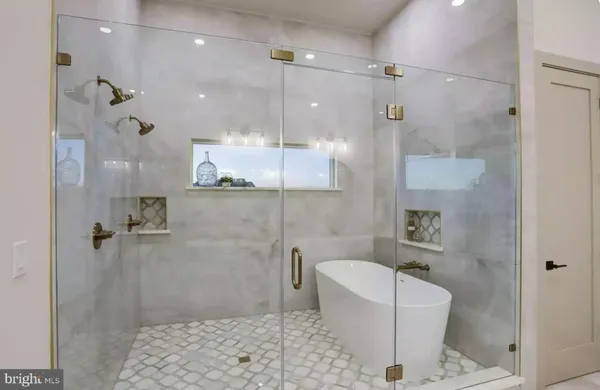 a bathroom with a bathtub a toilet and a shower