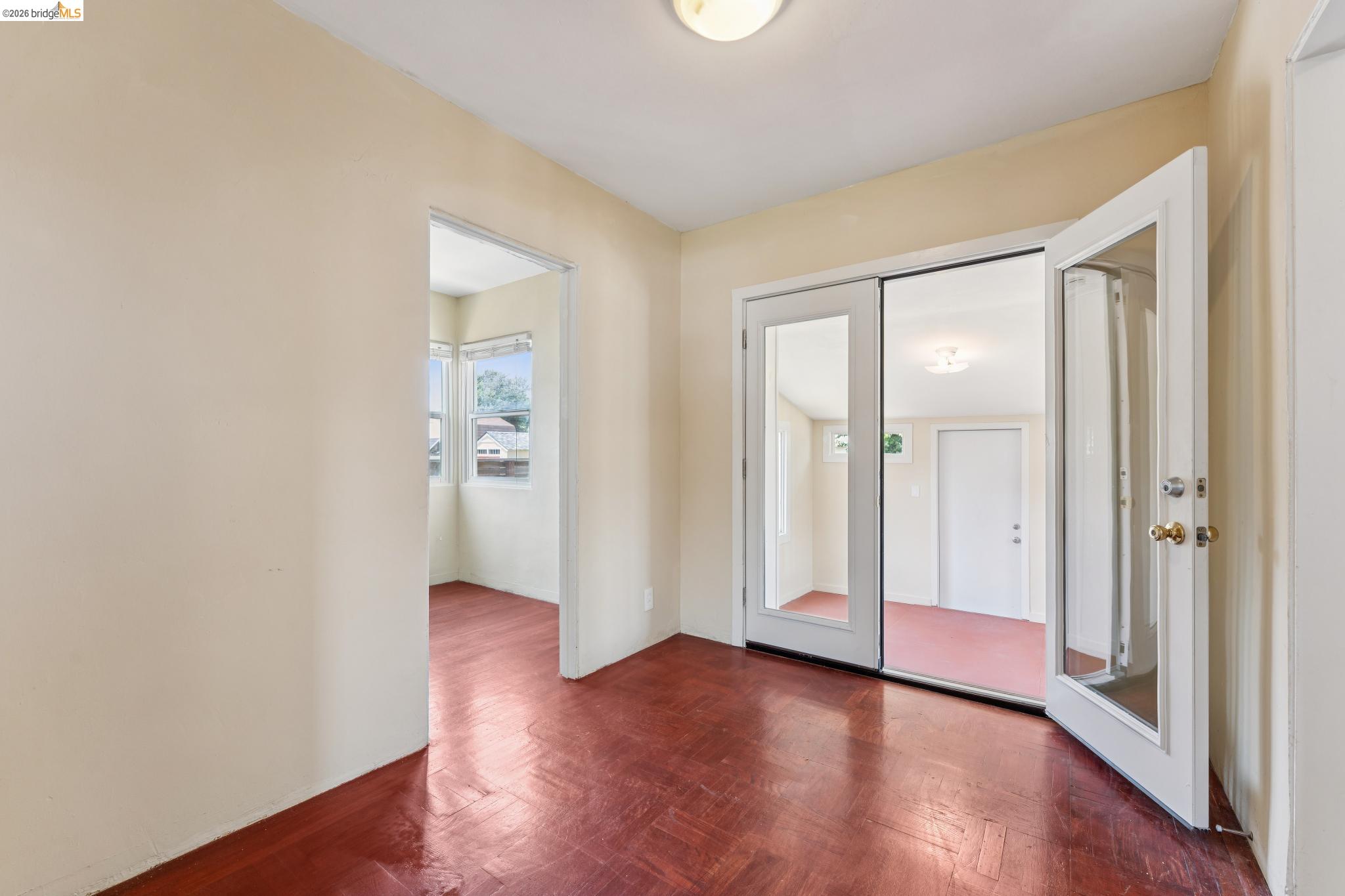2879 Rheem Avenue Richmond, CA 94804 - Photo 13 of 45 Interior room with wood-finish flooring, light-toned walls, and a ceiling-mounted light fixture