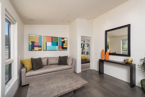 a bed sitting in a bedroom next to a large window