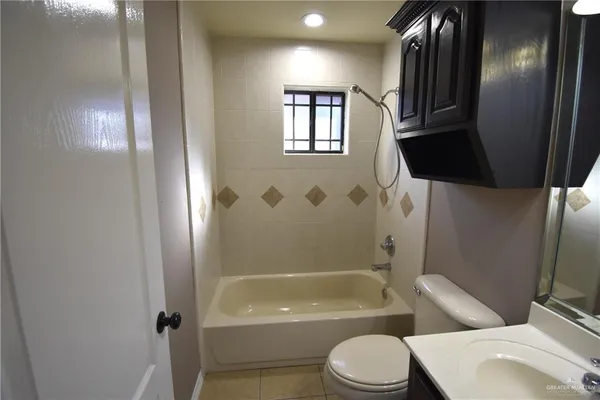a bathroom with a sink toilet and a mirror