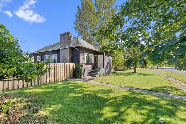 a view of a house with a yard and a garden
