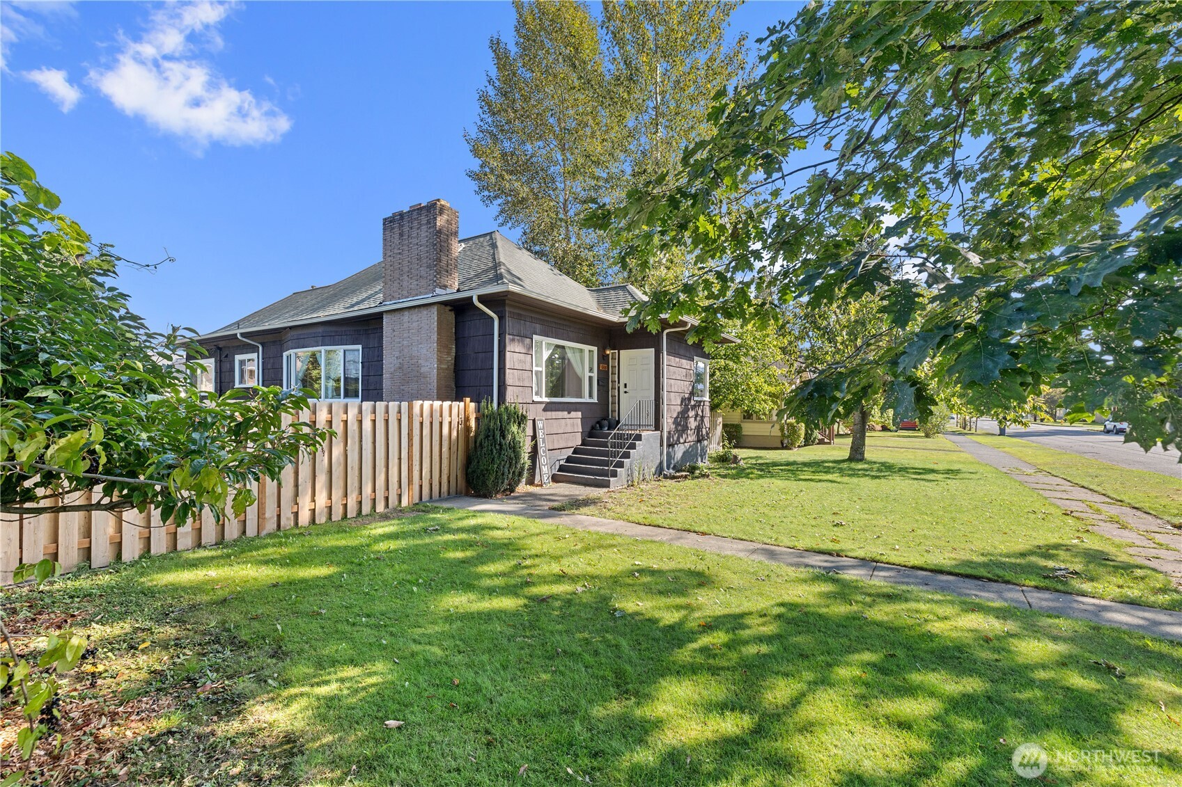 a view of a house with a yard and a garden