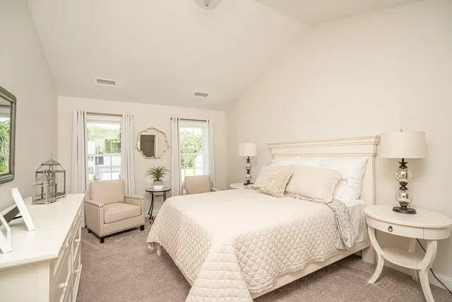 a bedroom with a bed and a large mirror