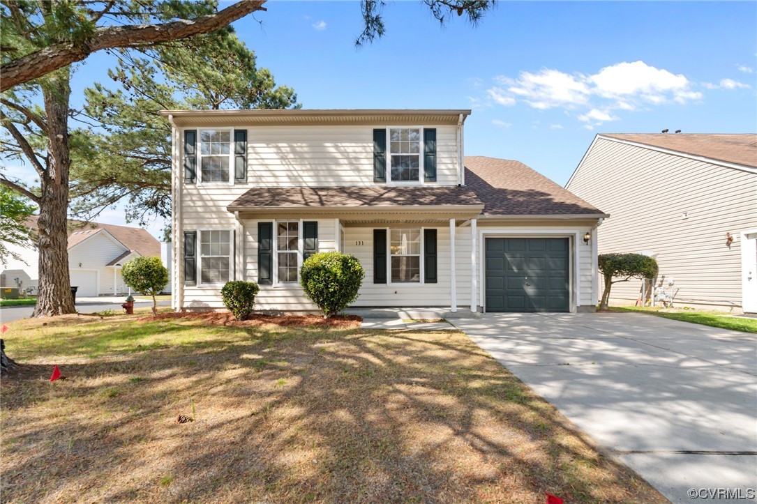 a front view of a house with a garden and patio