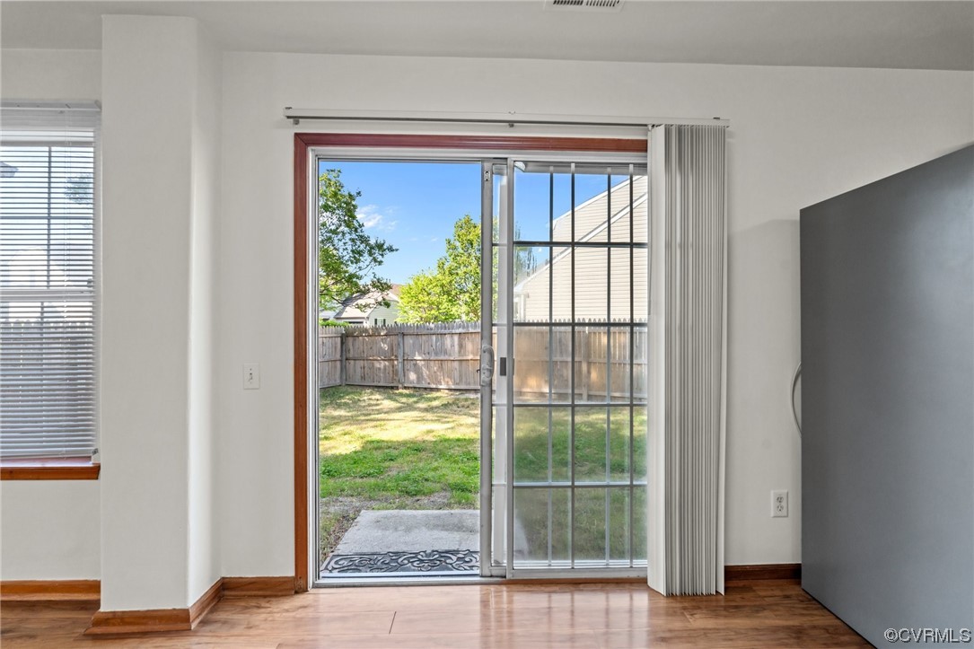 131 Stoney Ridge Avenue, Unit 52 Suffolk, VA 23435 - Photo 11 of 36 a view of an empty room with wooden floor and a window