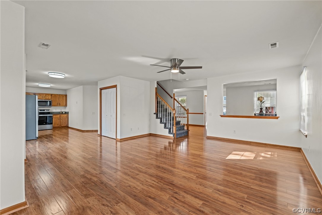 131 Stoney Ridge Avenue, Unit 52 Suffolk, VA 23435 - Photo 13 of 36 a view of an empty room with wooden floor and a window