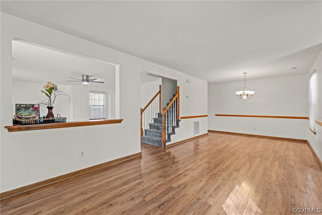 131 Stoney Ridge Avenue, Unit 52 Suffolk, VA 23435 - Photo 14 of 36 a view of an empty room with wooden floor and a window