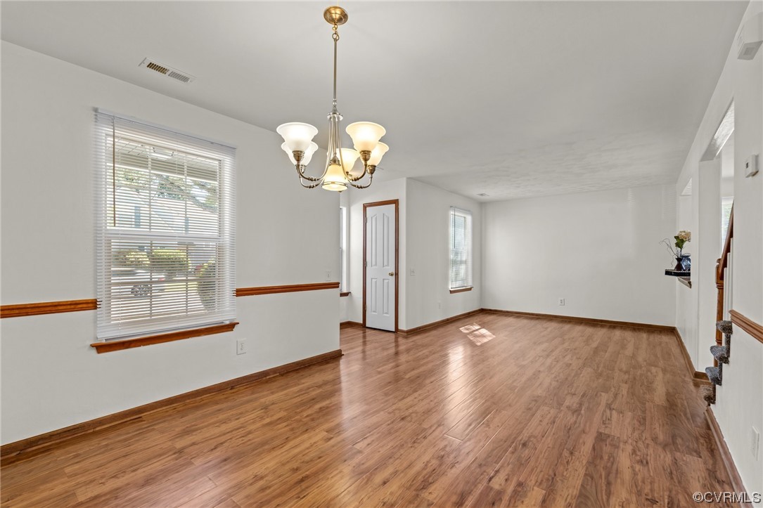 131 Stoney Ridge Avenue, Unit 52 Suffolk, VA 23435 - Photo 16 of 36 a view of an empty room with wooden floor and a window