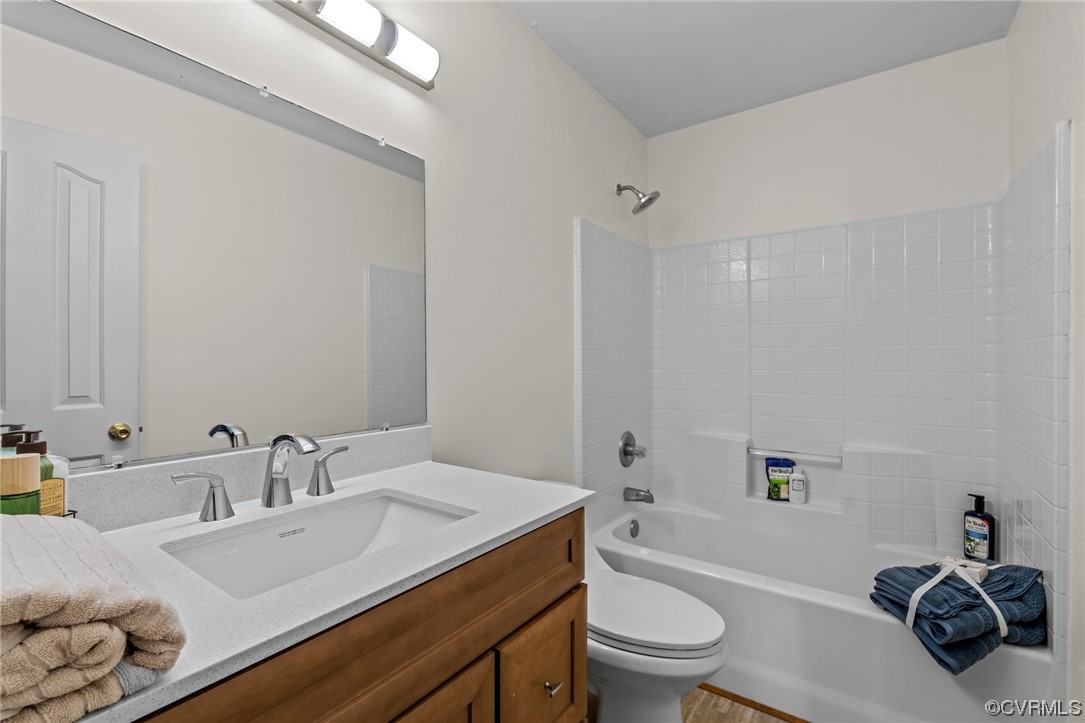 131 Stoney Ridge Avenue, Unit 52 Suffolk, VA 23435 - Photo 22 of 36 a bathroom with a granite countertop sink a toilet and shower