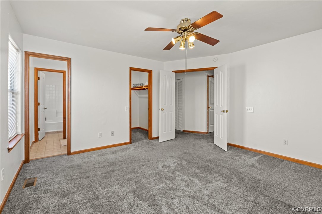 131 Stoney Ridge Avenue, Unit 52 Suffolk, VA 23435 - Photo 24 of 36 an empty room with closet and a chandelier fan