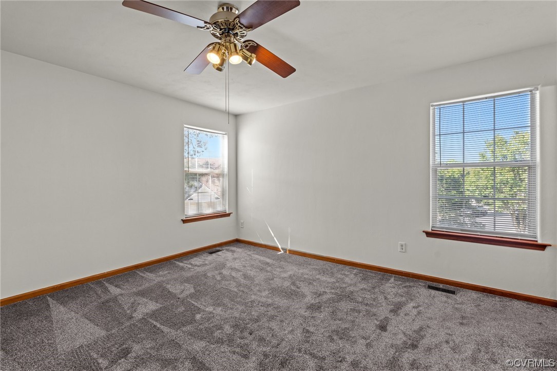 131 Stoney Ridge Avenue, Unit 52 Suffolk, VA 23435 - Photo 28 of 36 an empty room with windows and fan