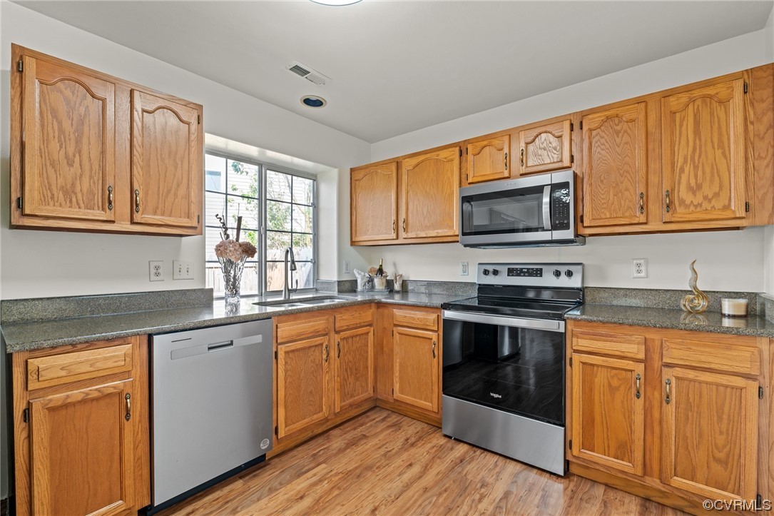 131 Stoney Ridge Avenue, Unit 52 Suffolk, VA 23435 - Photo 6 of 36 a kitchen with stainless steel appliances granite countertop wooden cabinets a sink and a stove