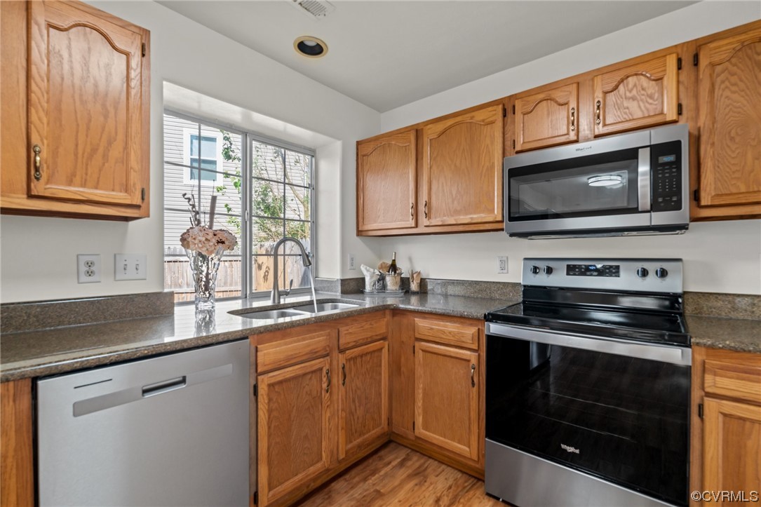 131 Stoney Ridge Avenue, Unit 52 Suffolk, VA 23435 - Photo 7 of 36 a kitchen with cabinets stainless steel appliances a sink and a microwave