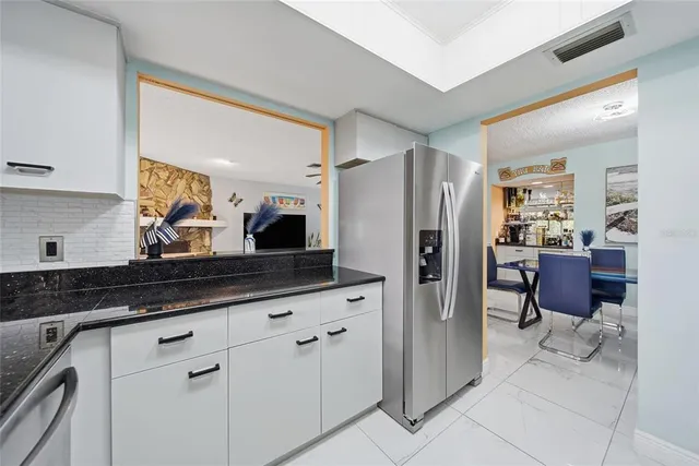 a kitchen with stainless steel appliances a refrigerator and cabinets