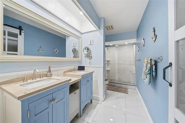 a spacious bathroom with a shower sink and mirror