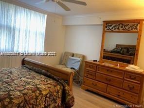 3606 South Ocean Boulevard, Unit 504 Highland Beach, FL 33487 - Photo 15 of 26 a bedroom with a bed and wooden floor