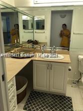 3606 South Ocean Boulevard, Unit 504 Highland Beach, FL 33487 - Photo 16 of 26 a bathroom with a granite countertop sink and a mirror