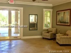 a living room with furniture and a floor to ceiling window