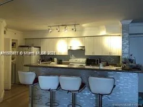 a kitchen with a sink cabinets and window